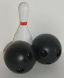 A bowling pin with two bowling balls